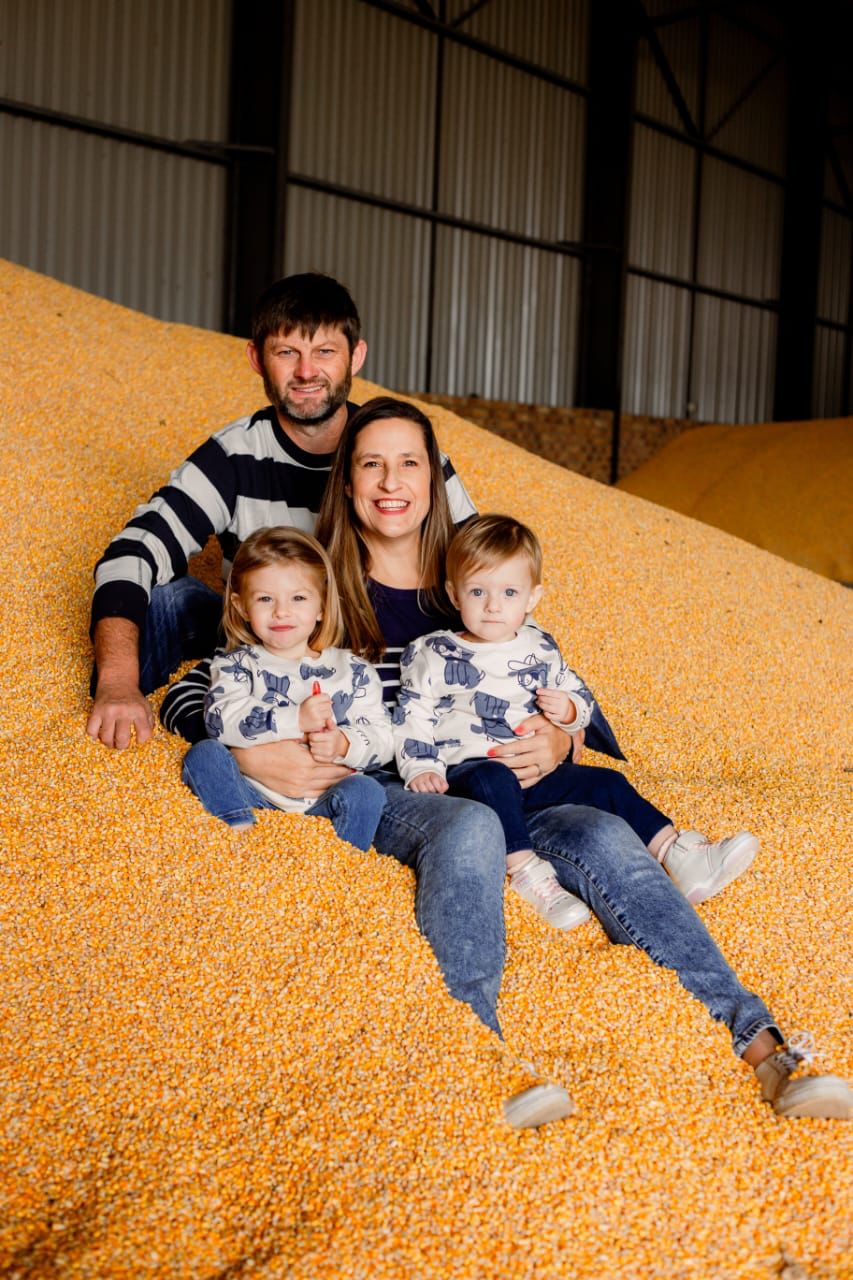 Hendrik Odendaal and family on a heap of maize
